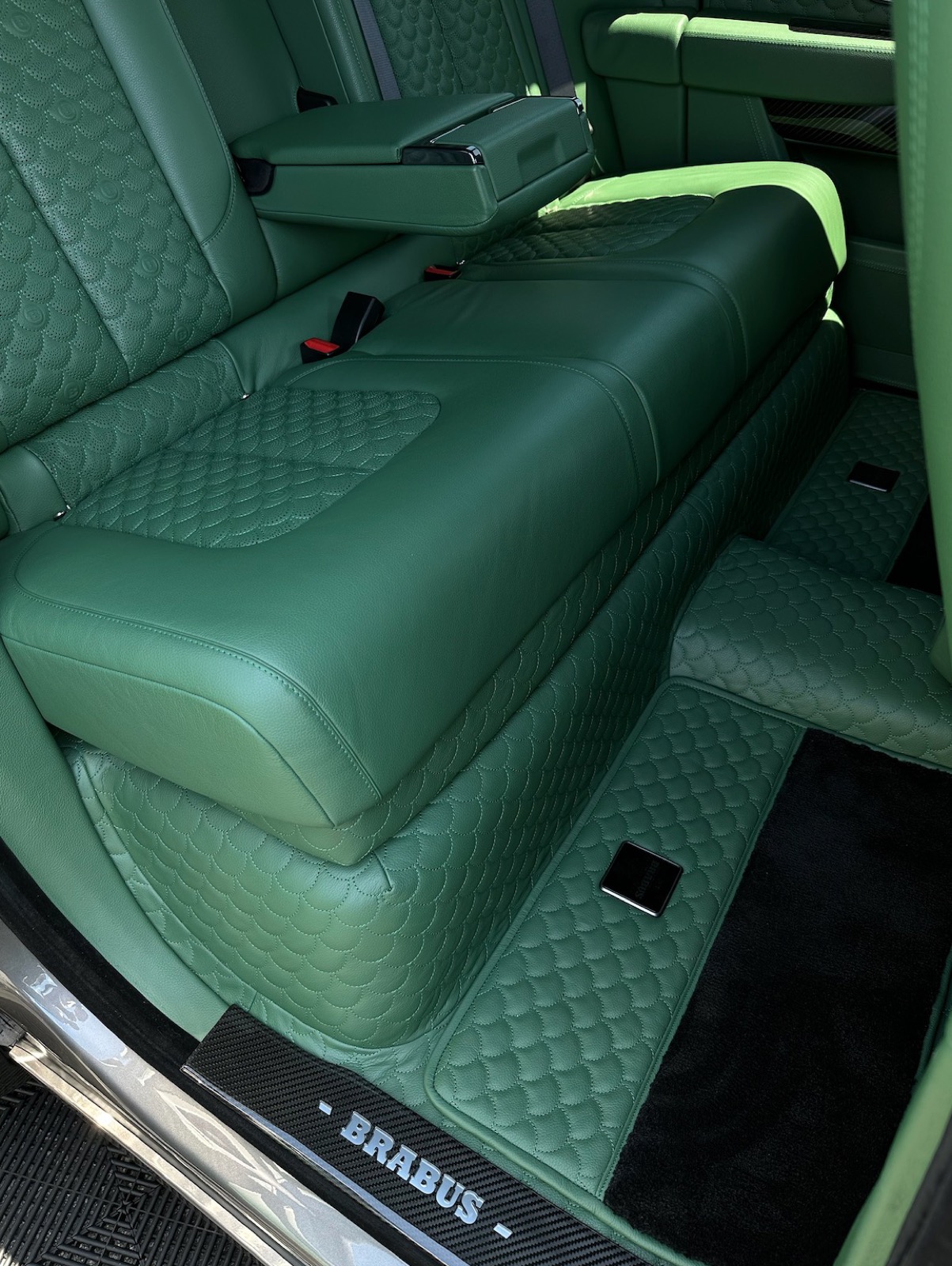 Detailed green quilted-leather rear cabin of a Brabus