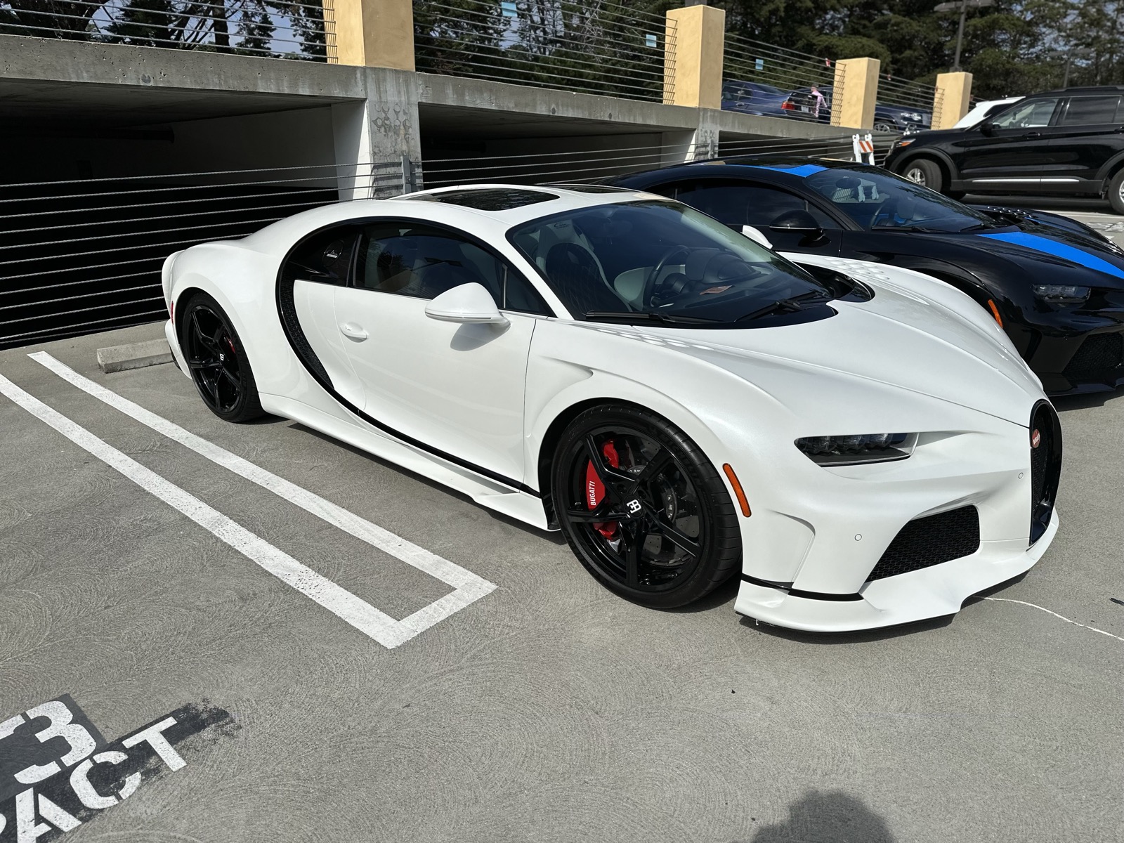 Freshly detailed white Bugatti Chiron parked outside a garage
